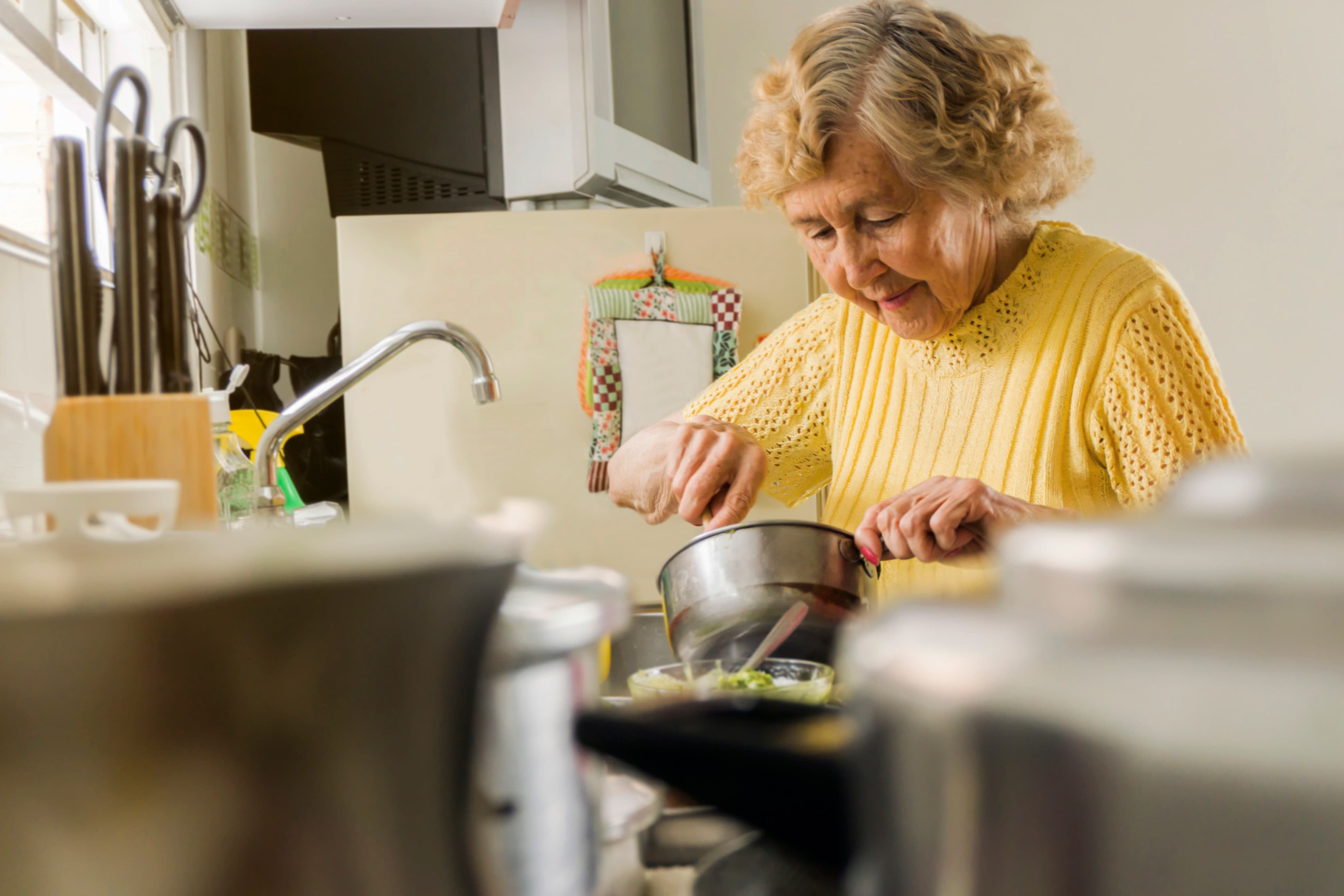 Older woman cooking in her kitchen